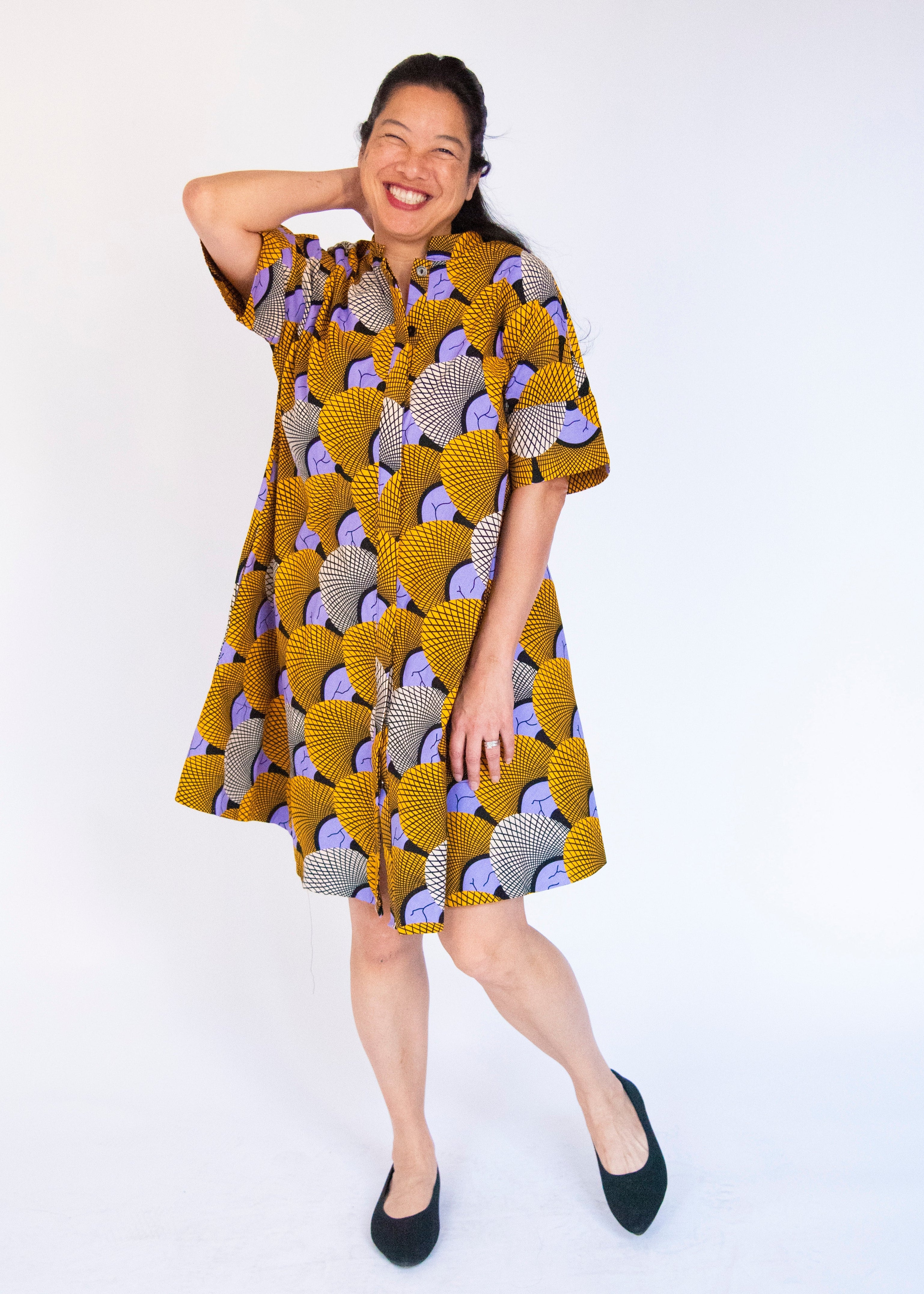 Model wearing orange and purple dress.