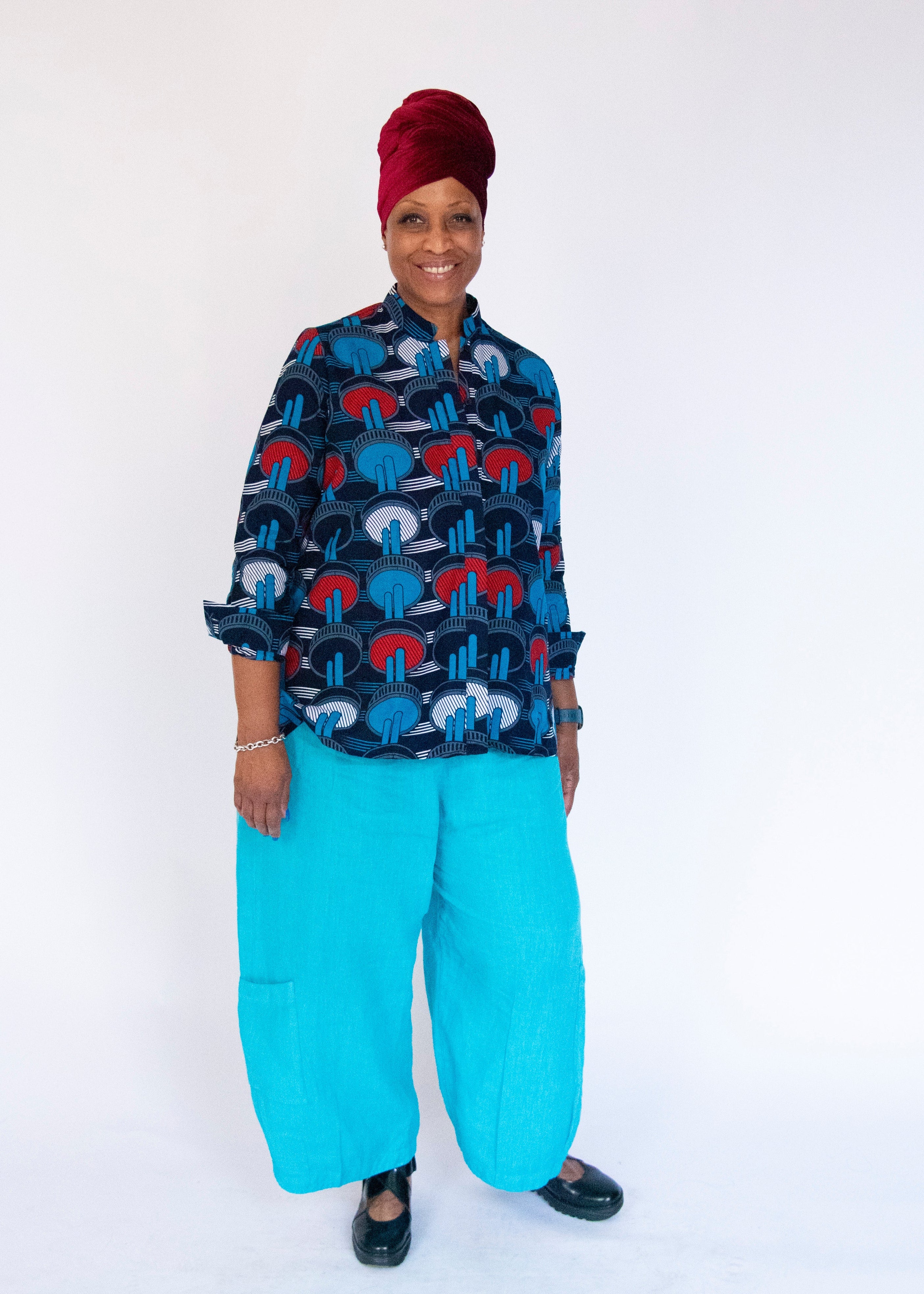 Model wearing blue, red and white graphic shirt.