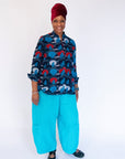 Model wearing blue, red and white graphic shirt.