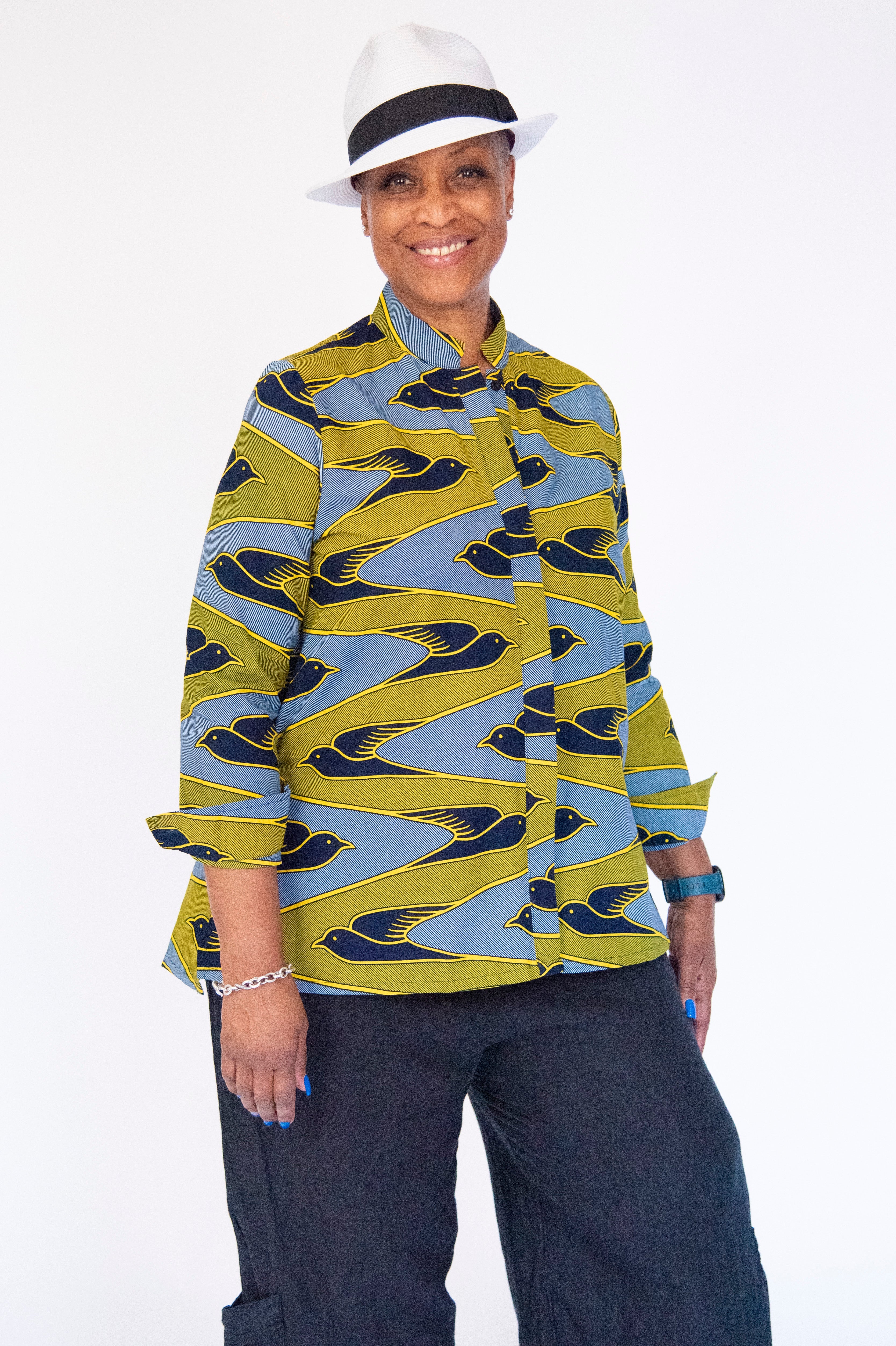 Model wearing yellow, navy and white dove print shirt.