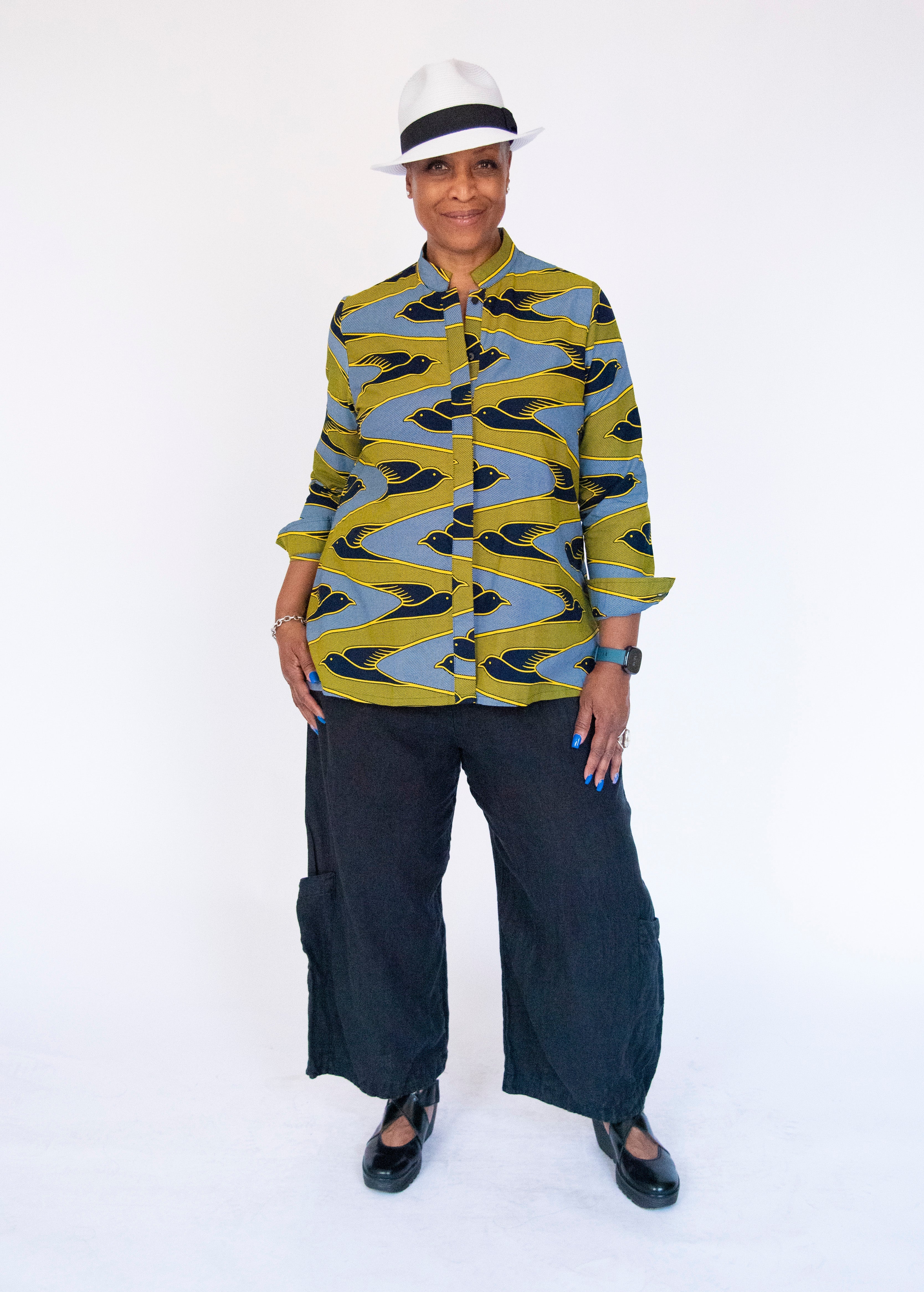 Model wearing yellow, navy and white dove print shirt.