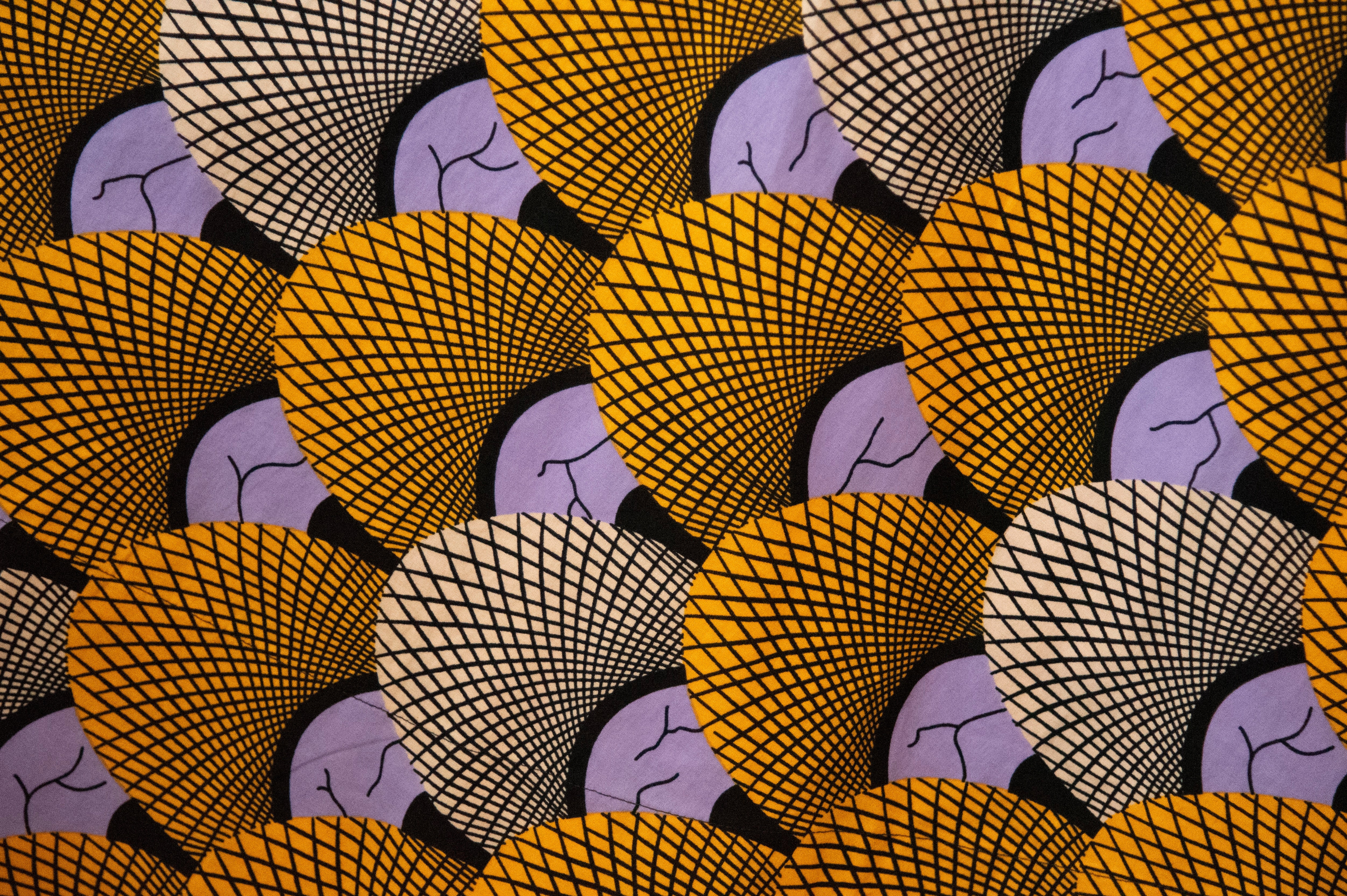 Close up display of orange and purple dress, fabric.
