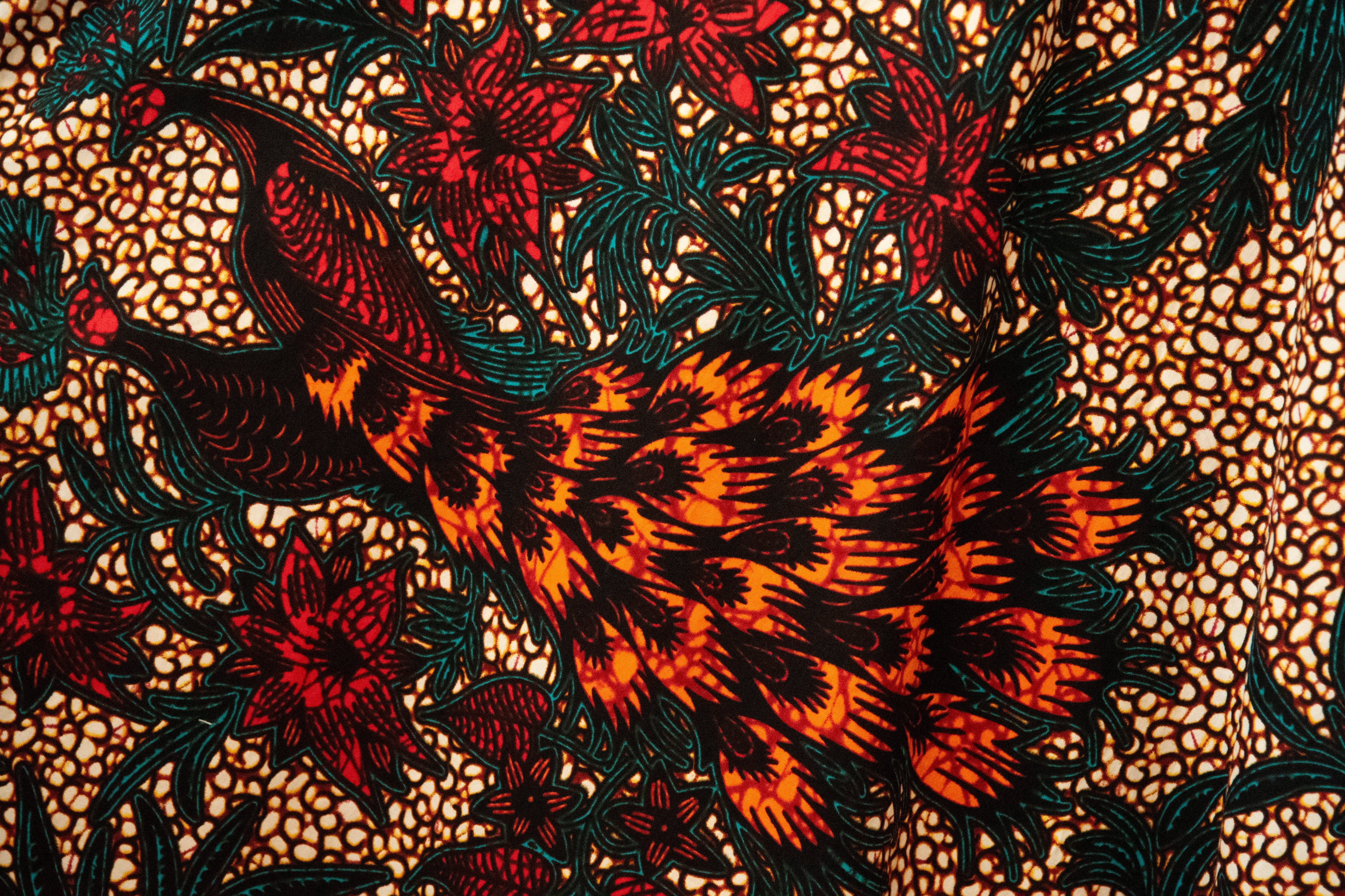 Close up display of orange, brown and green dress, fabric