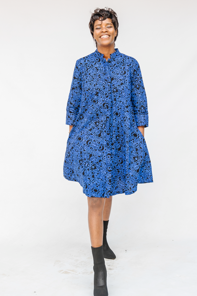 Model wearing black and blue floral dress.