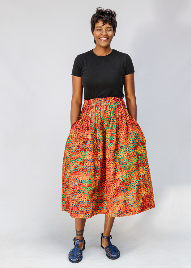 Model wearing multicolored dot print skirt.