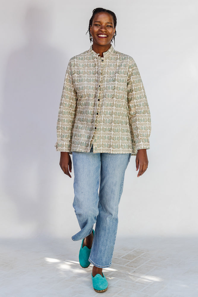 Model wearing long sleeved shirt with small owl print.