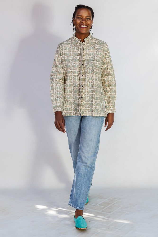 Model wearing long sleeved shirt with small owl print.