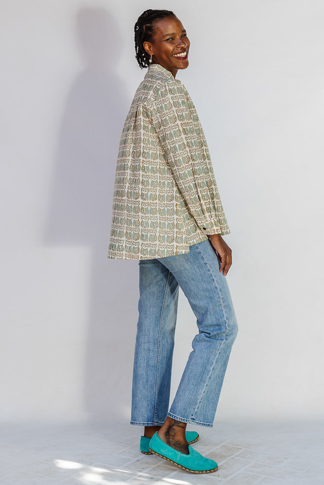 Model wearing long sleeved shirt with small owl print.