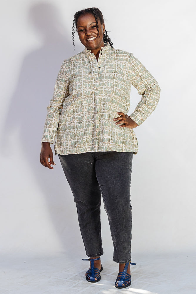 Model wearing long sleeved shirt with small owl print.