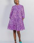 Model wearing purple and pink plaid batik dress.