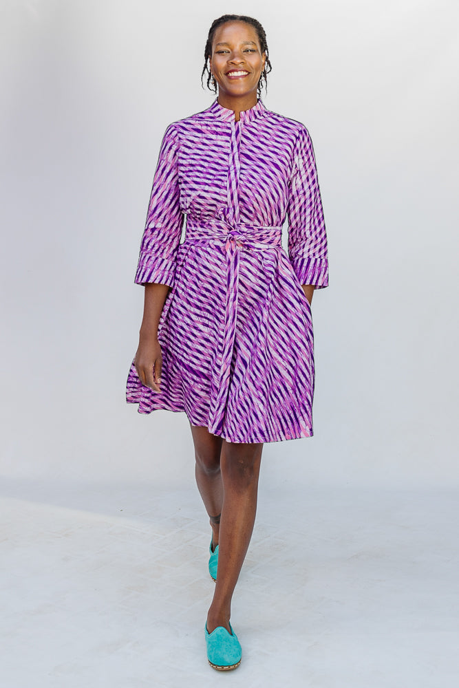Model wearing purple and pink plaid batik dress.