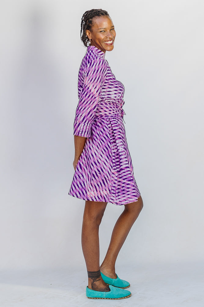 Model wearing purple and pink plaid batik dress.