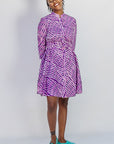 Model wearing purple and pink plaid batik dress.
