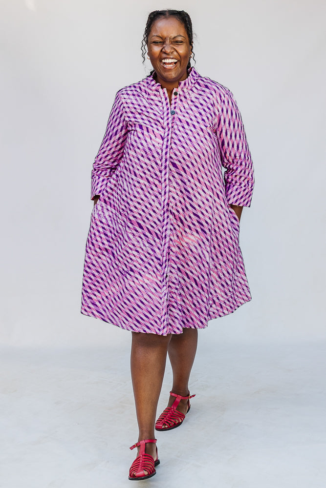Model wearing purple and pink plaid batik dress.