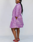 Model wearing purple and pink plaid batik dress.