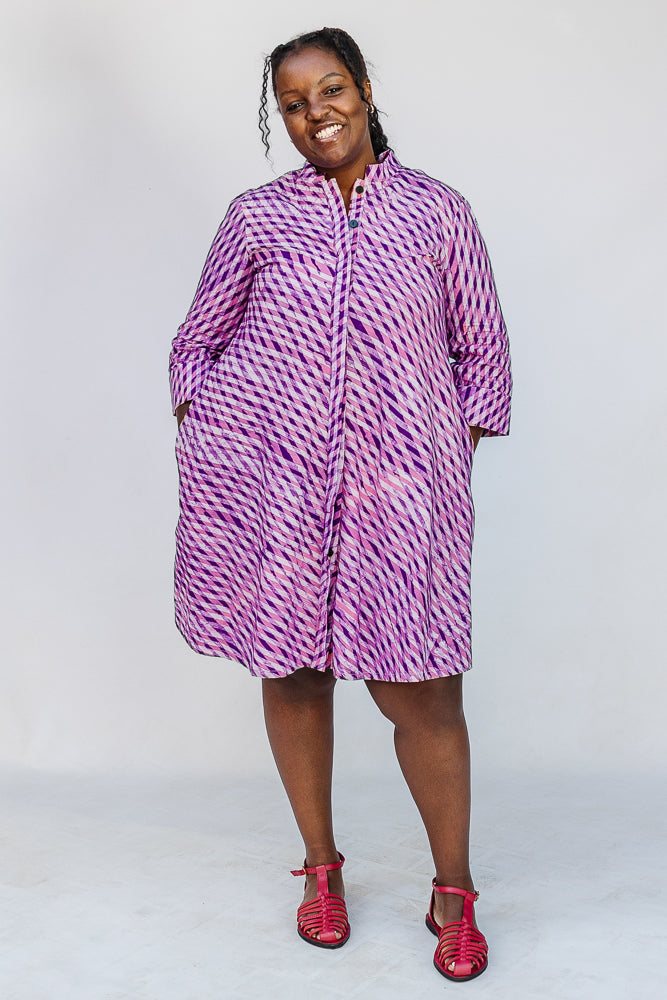 Model wearing purple and pink plaid batik dress.
