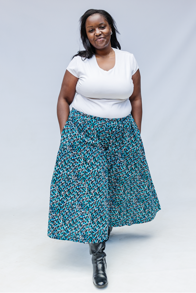 Model wearing aqua, black and white culottes.