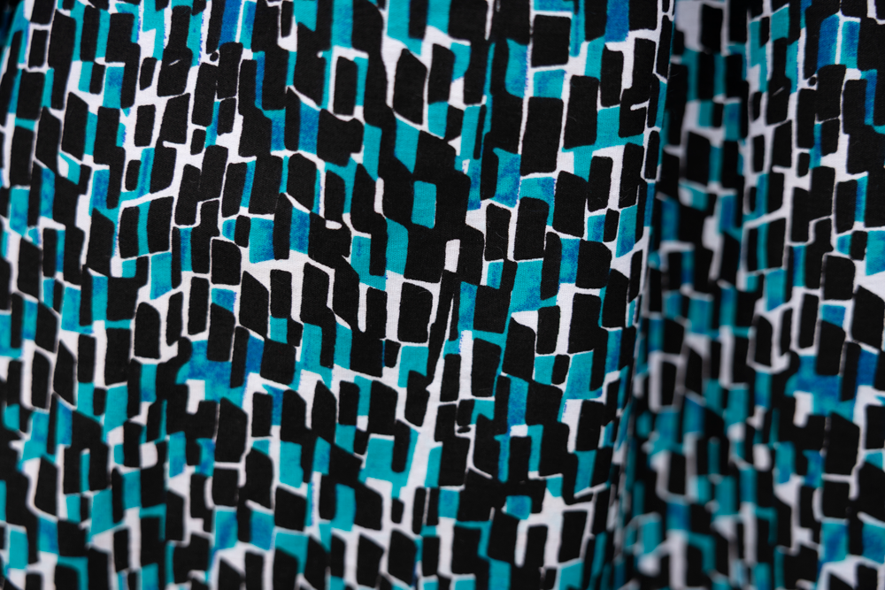 Close up display of aqua, black and white culotte, fabric.