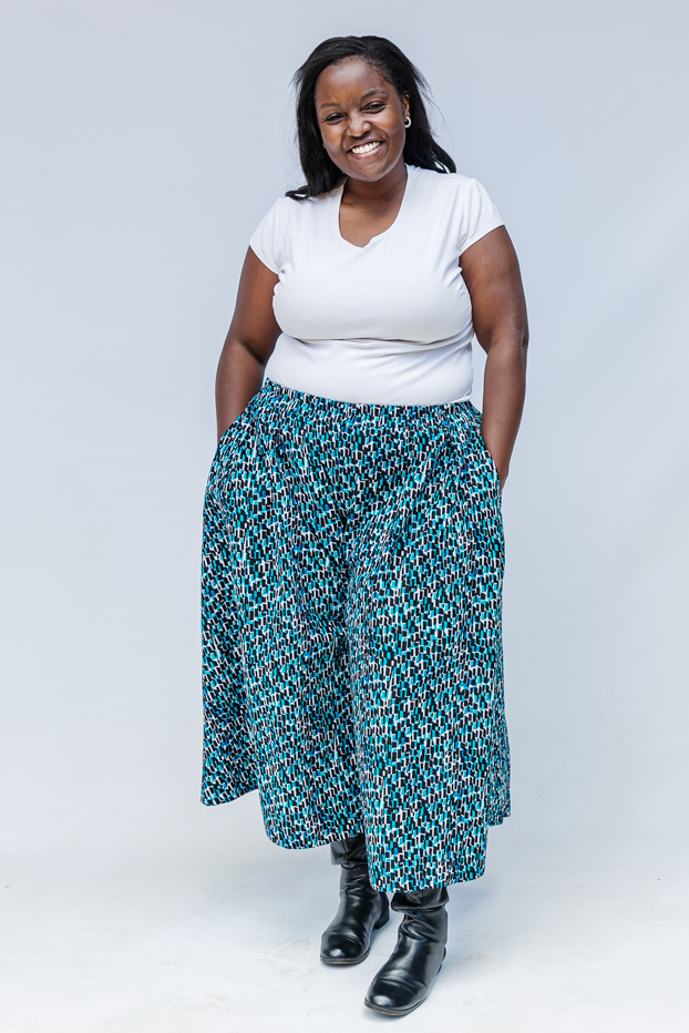 Model wearing aqua, black and white culottes.