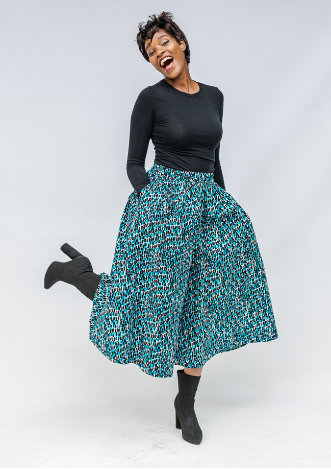 Model wearing aqua, black and white culottes.