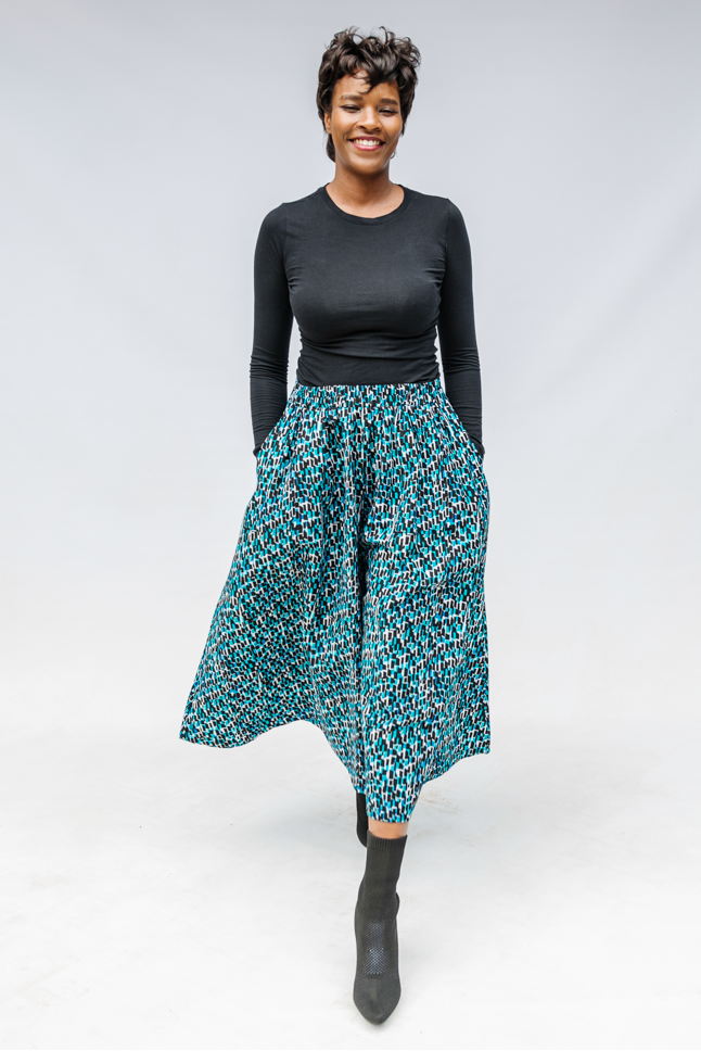 Model wearing aqua, black and white culottes.
