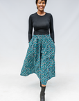 Model wearing aqua, black and white culottes.