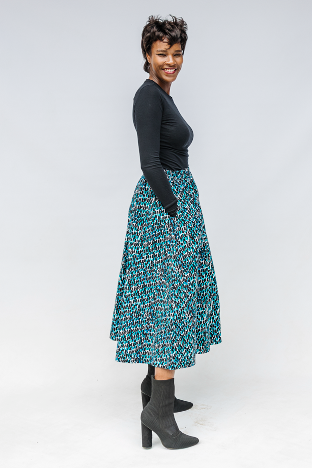 Model wearing aqua, black and white culottes.