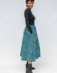 Model wearing aqua, black and white culottes.