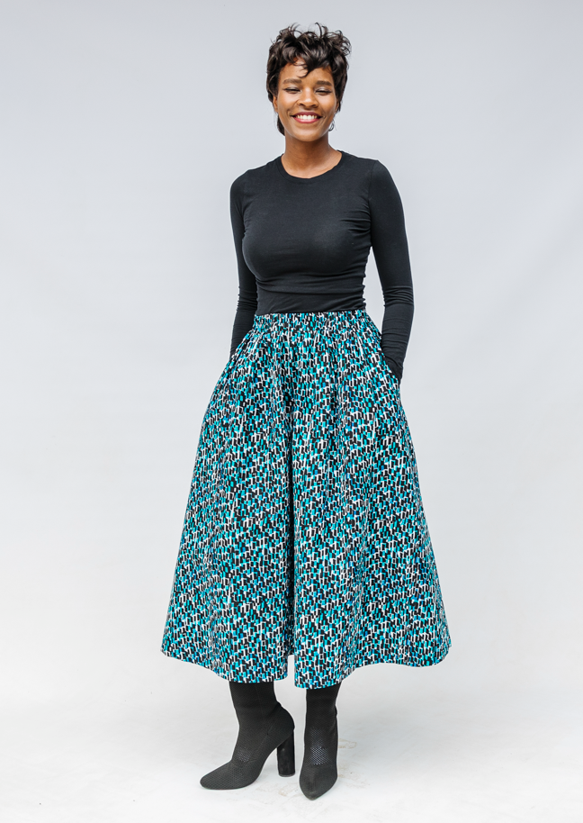Model wearing aqua, black and white culottes.