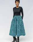 Model wearing aqua, black and white culottes.