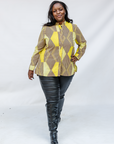 Model wearing yellow, brown and white abstract print shirt.