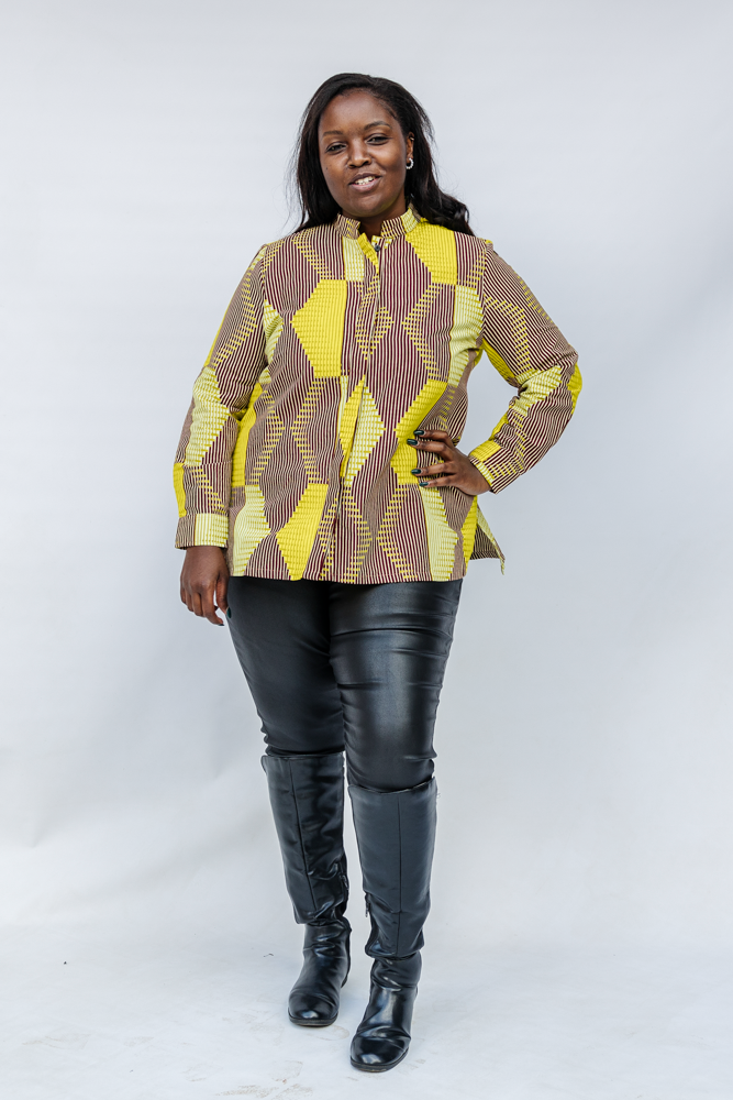 Model wearing yellow, brown and white abstract print shirt.