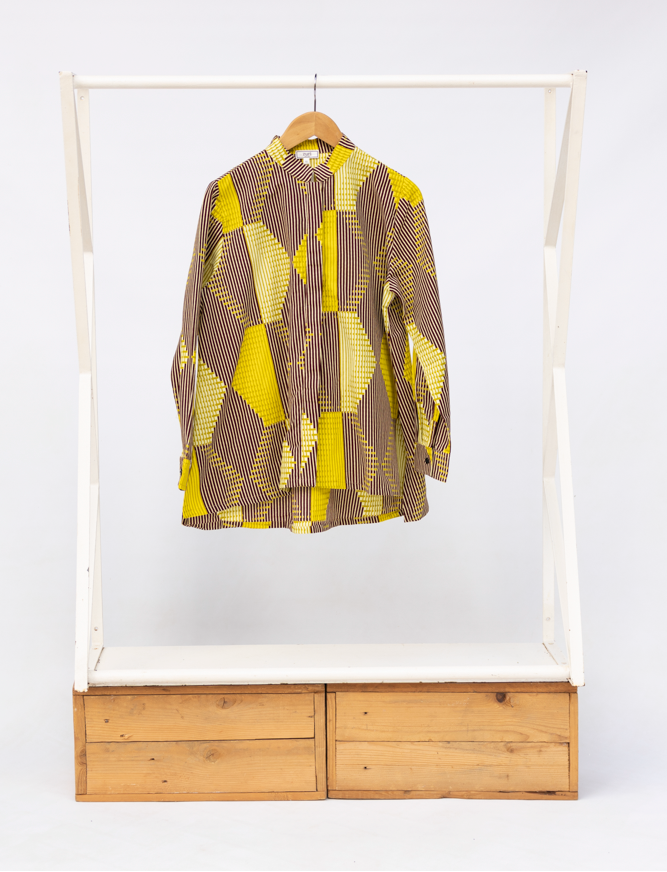 Display of yellow, brown and white abstract print shirt.
