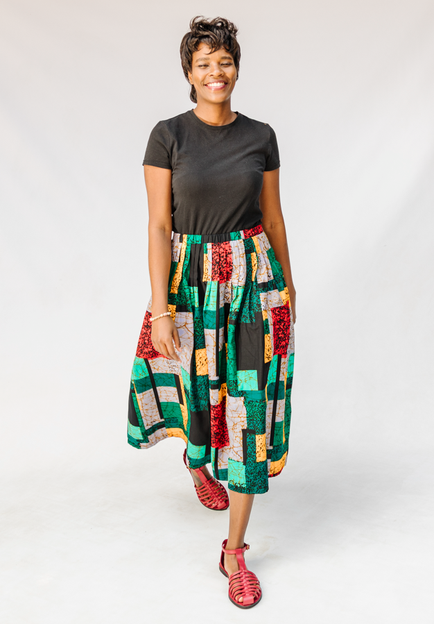 Model wearing multicolored geometric print skirt.