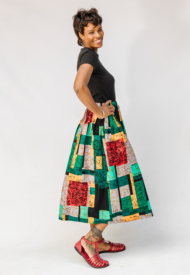 Model wearing multicolored geometric print skirt.