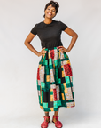 Model wearing multicolored geometric print skirt.