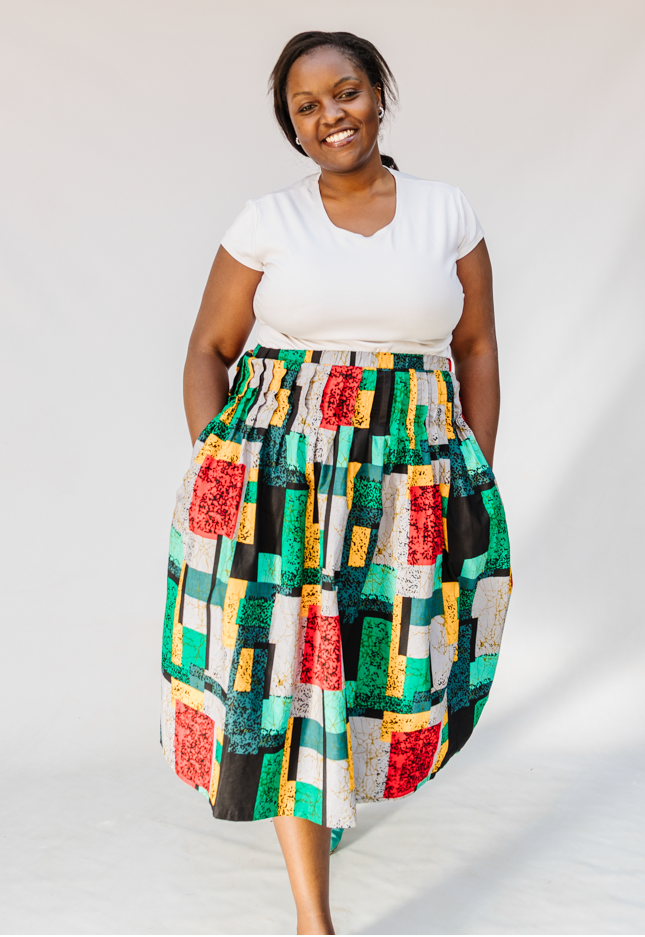 Model wearing multicolored geometric print skirt.