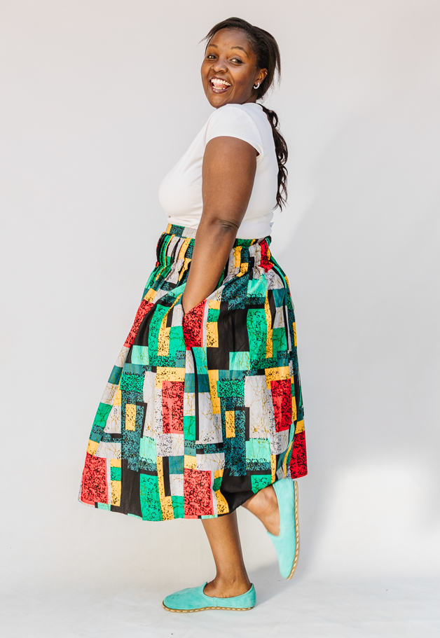 Model wearing multicolored geometric print skirt.