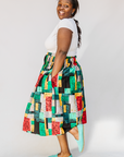 Model wearing multicolored geometric print skirt.