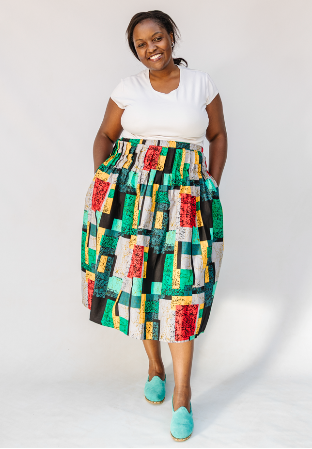 Model wearing multicolored geometric print skirt.