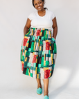 Model wearing multicolored geometric print skirt.