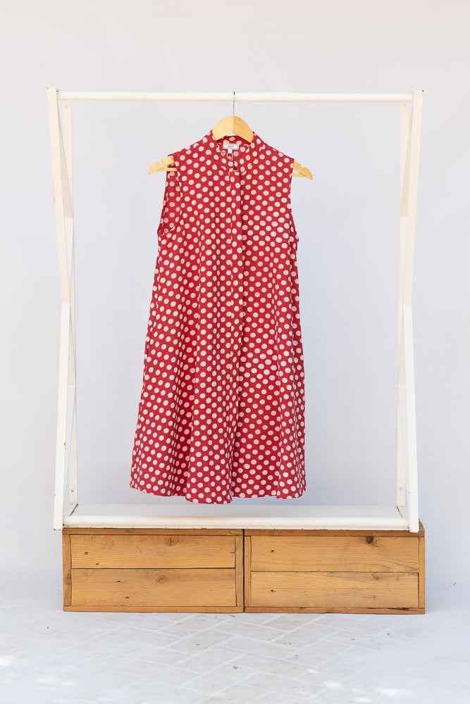 Display of red sleeveless dress with white dots.