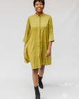 Model wearing olive green linen dress.