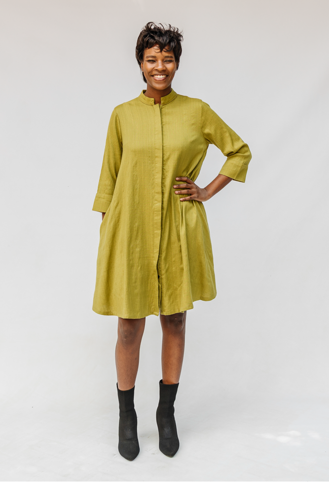 Model wearing olive green linen dress.