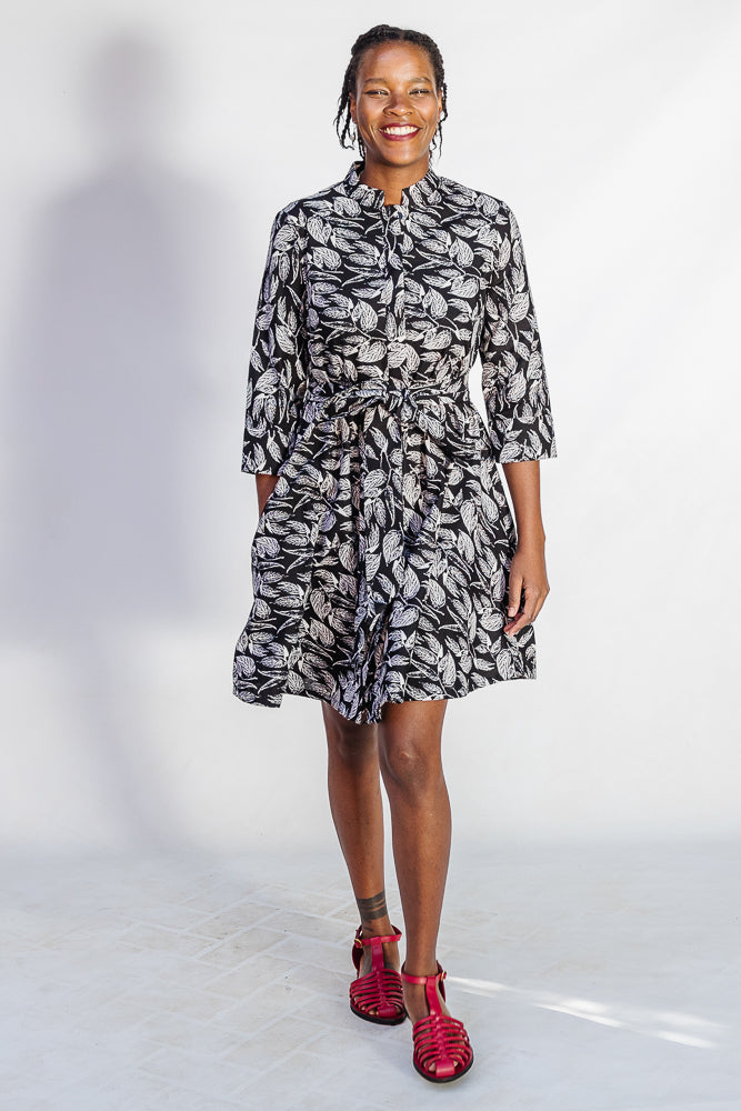 Model wearing black and white leaf print dress.