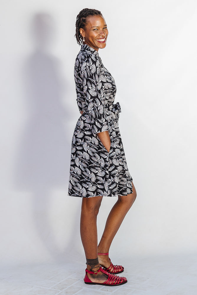 Model wearing black and white leaf print dress.