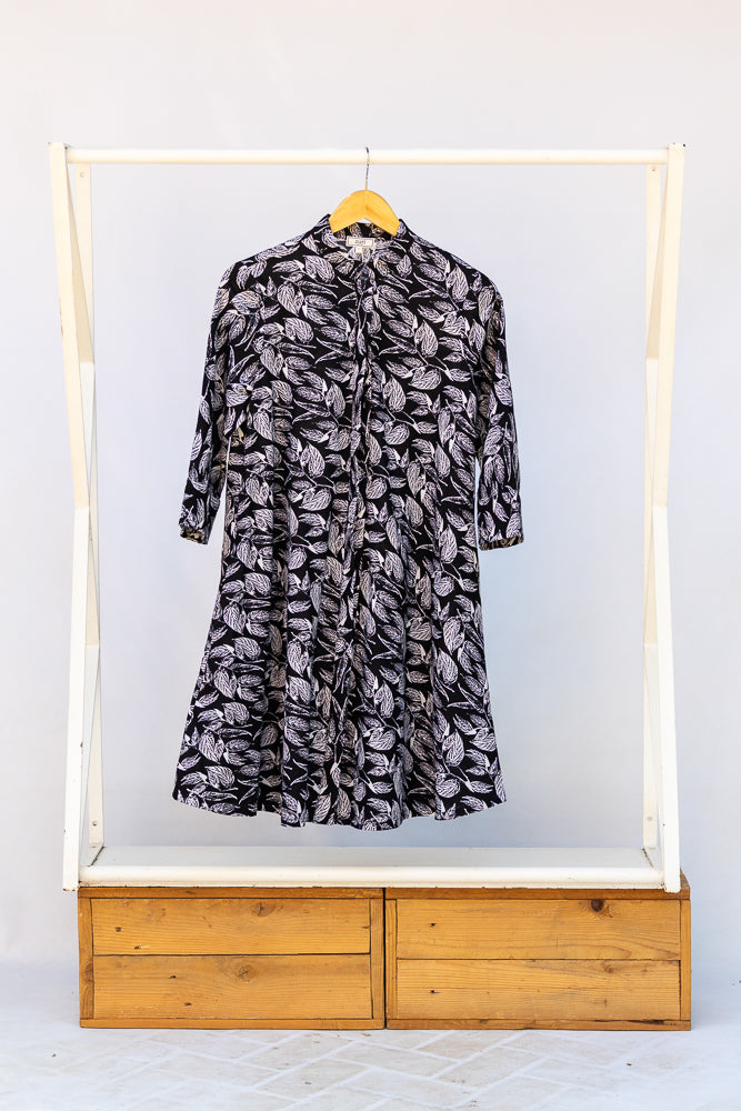 Display of black and white leaf print dress.