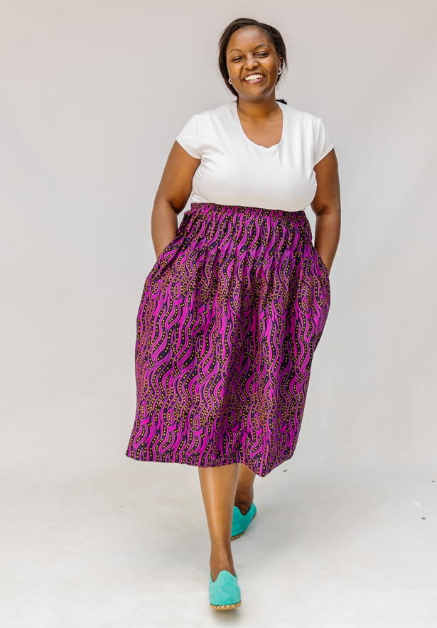 Model wearing fuchsia skirt with small dot design.