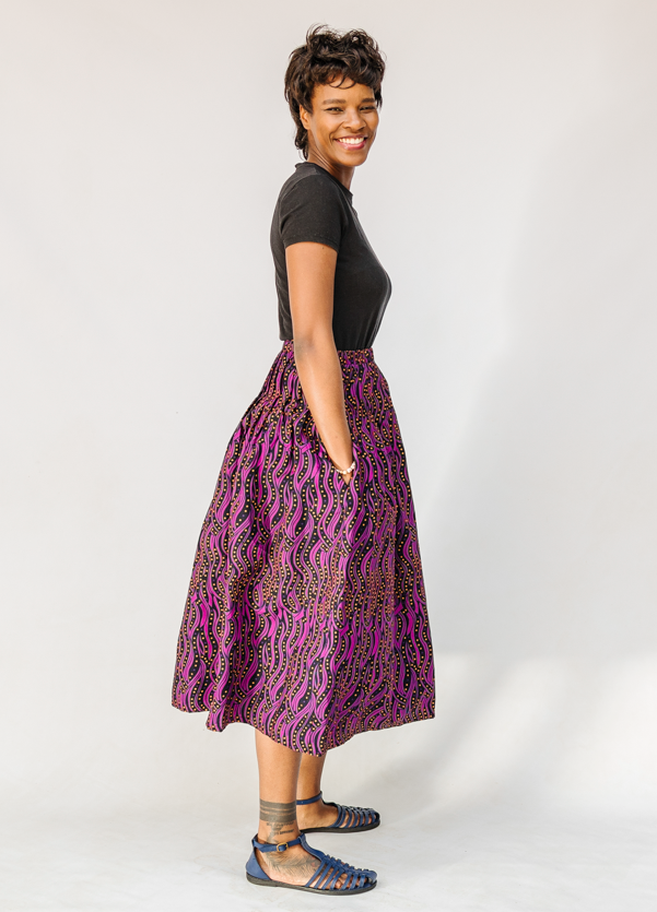 Model wearing fuchsia skirt with small dot design.