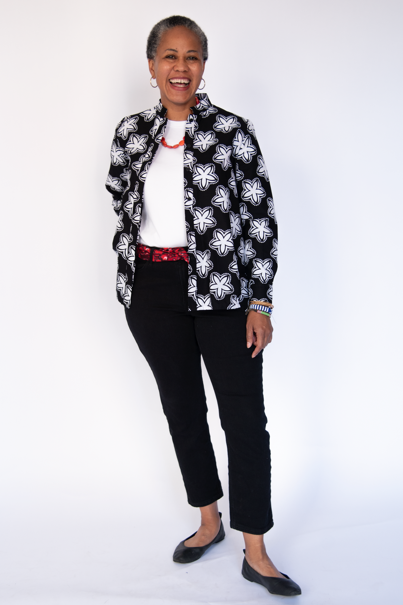 Model wearing black and white flower print shirt.